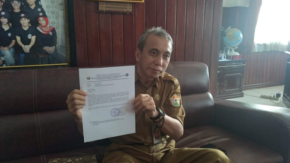 Kepala SMK Negeri 2 Kendari, Mohammad Fadjar Sene saat memperlihatkan surat pengembalian guru Nurkadas ke Dikmudora Kota Kendari.