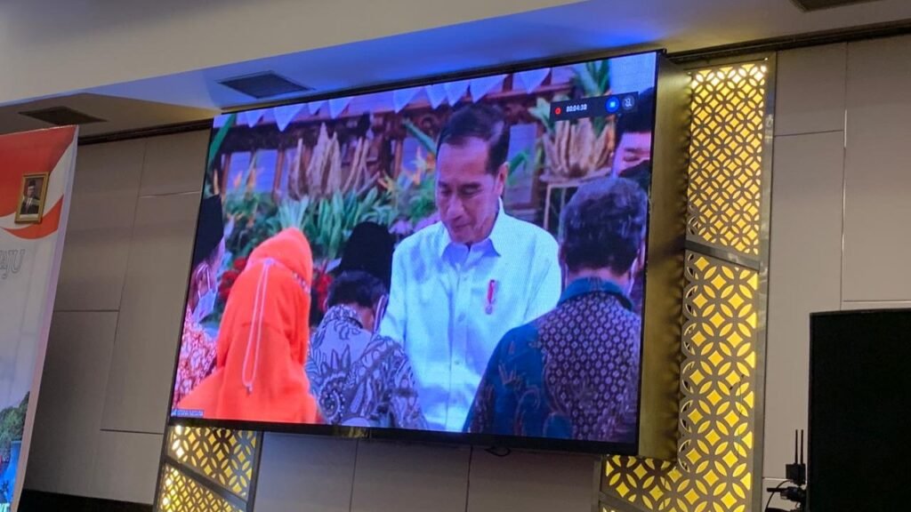 Presiden Jokowi saat menyerahkan sertifikat secara simbolis kepada masyarakat. 
